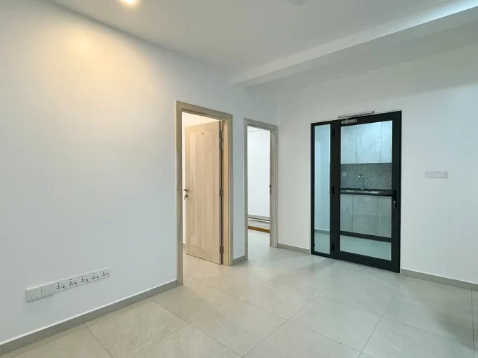 Brand new unfurnished 2 bedroom apartment on the 1st and 2nd floors of a residential building in Fiyaathoshi Magu, Maafannu, Male'. A photo of the living area and closed kitchen.